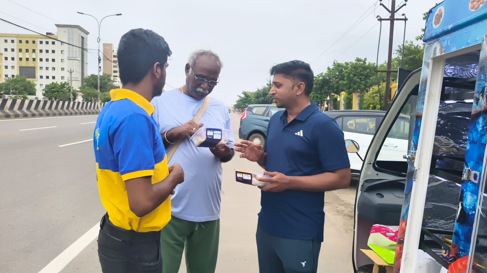 Team sharing KatchFresh products during vehicle market campaign